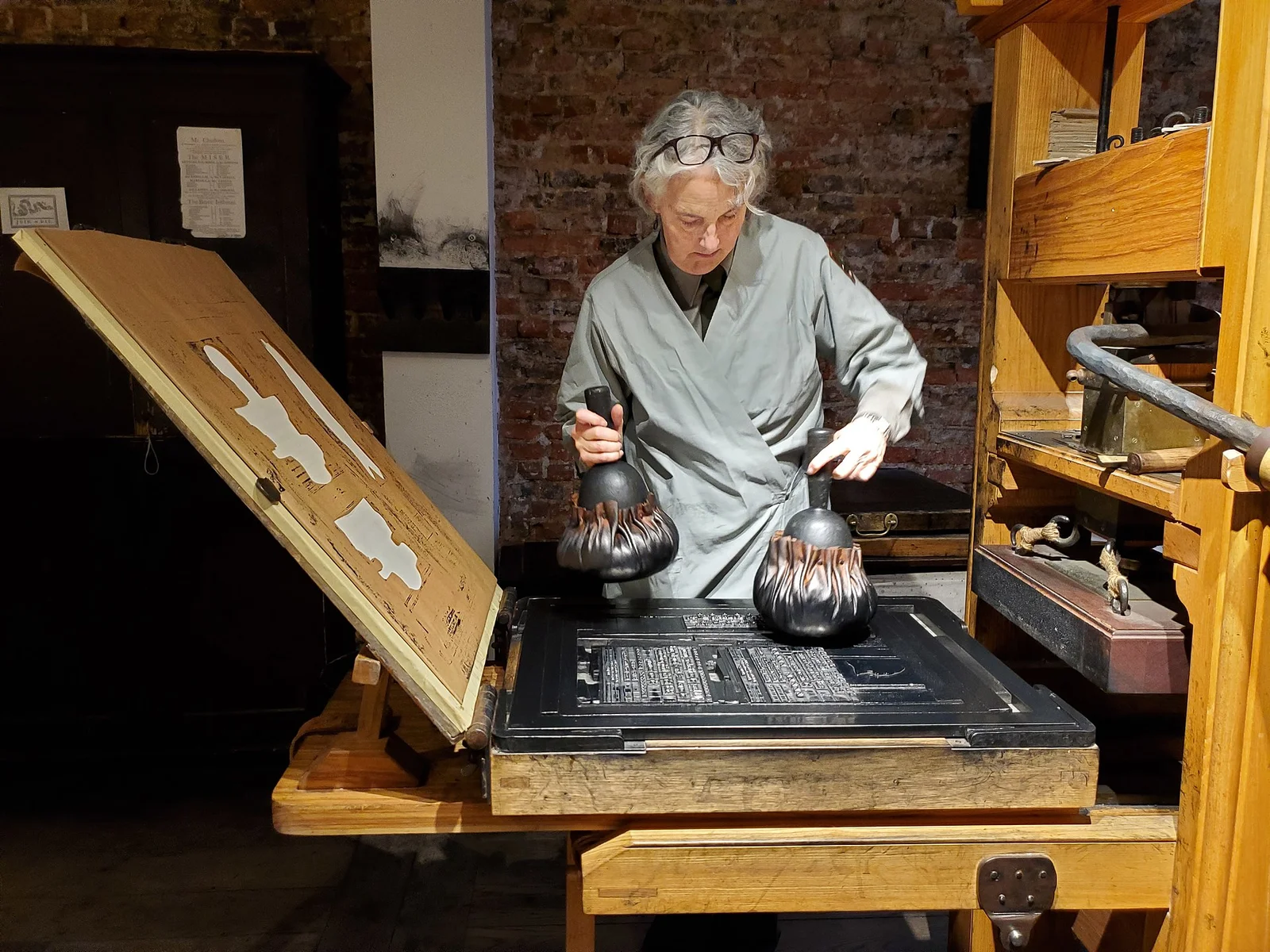 18th Century Printing Press Demonstration - Park Ranger demonstrating adding ink to the typesetting
